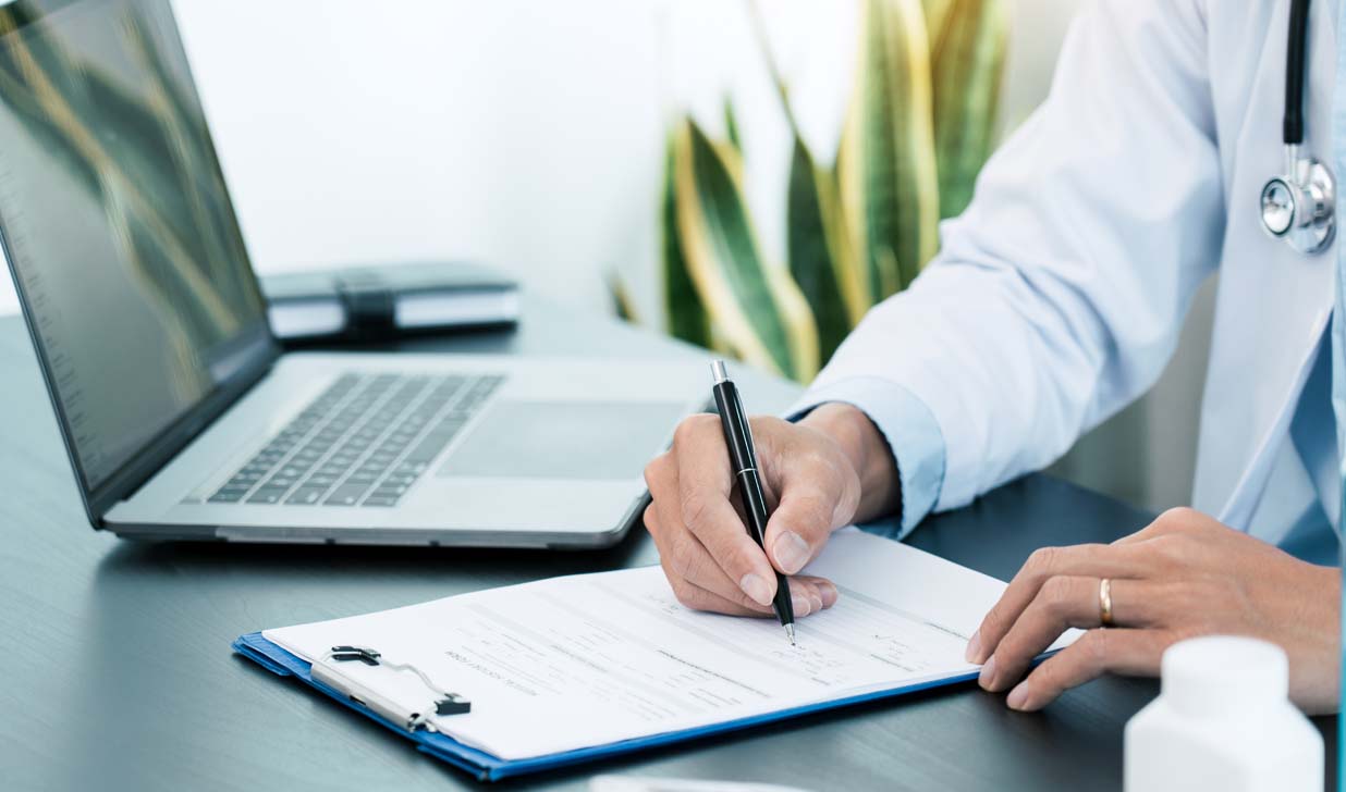 Doctor hand holding a pen and writing patient history list