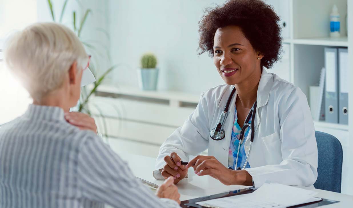 Female doctor exmining elderly female patient