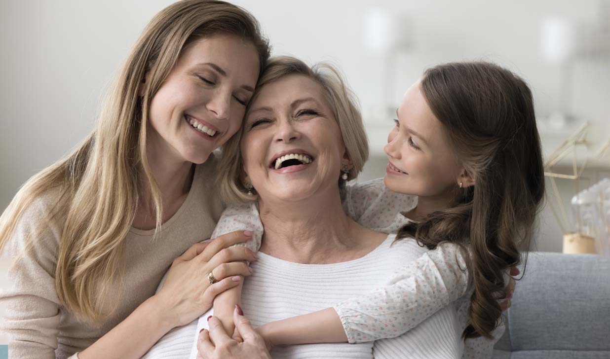 Joyful grandkid girl and womans hugging